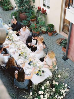 a group of people sitting around a table eating food