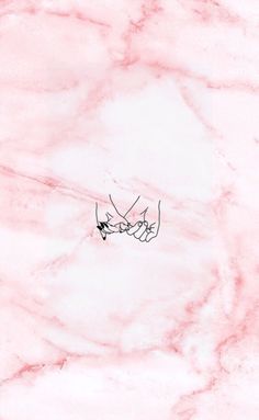 two hands touching each other on a pink marble background