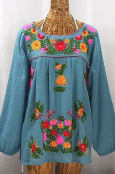 "* Ornate hand embroidery and elegant long sleeves with puff cuffs, available here in POOL BLUE with BRIGHT MULTI MIX embroidery. * Light, gauzy and semi-sheer 100% cotton throughout; wear it billowy and flowing in the traditional bohemian style. * Entirely hand dyed, distressed and embroidered for an authentic, retro-vintage and hippie casual vibe. * Our ornate butterfly floral embroidery patterns are a faithful tribute to the original Mexican style hippie blouses of the 1970's. * Caringly embr Mexican Peasant Blouse, Embroidery Light, Hippie Blouse, Mexican Blouse, Pool Blue, Floral Embroidery Patterns, Geometric Embroidery, Embroidery Gifts, Pretty Blouses