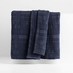 two dark blue towels folded on top of each other