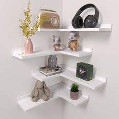 there are three shelves that have various items on top of each shelf, including headphones and books