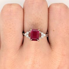 This beautiful ring features an emerald-cut ruby with a triad of natural earth-mined diamonds on both sides, all set in solid 14K white gold. This ring can be a lovely July birthstone gift for your loved ones! This ring is made with solid 14K Gold and naturally Earth-mined SI / G-H diamonds. If you're interested in purchasing this setting with a different center stone please message us! Red Ruby Ring, Designer Silver Jewellery, Night Christmas, Jewelry Appraisal, Jewelry Showcases, Solitaire Studs, Minimalist Ring, July Birthstone, Red Ruby