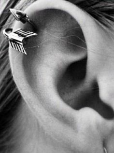 an ear piercing with two arrows on it