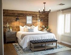 a bedroom with wood paneling and white bedding