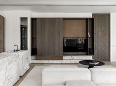 a modern living room with marble and wood accents