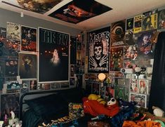 a bedroom with many posters on the wall