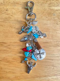 a key chain with charms on it sitting on a table