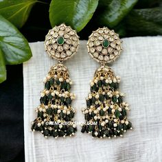 **Kundan Green Moissanite Jhumka Earrings - Elegant Bollywood Wedding Jewelry** Add a touch of timeless elegance to your jewelry collection with these exquisite Kundan Green Moissanite Jhumka Earrings. Perfect for weddings, Bollywood-inspired events, or any festive occasion, these earrings are a stunning example of traditional Indian craftsmanship. **Key Features - **High-Quality Materials Crafted with premium Kundan stones and green moissanite, these earrings offer a radiant sparkle that rivals Green Dangle Jhumkas For Festive Occasions, Green Latkan Bridal Earrings For Diwali, Green Bridal Earrings With Latkans For Diwali, Green Latkans Bridal Earrings For Diwali, Green Bridal Earrings With Latkans For Celebration, Green Bridal Earrings With Latkans For Festivals, Green Chandbali Bridal Earrings With Latkans, Green Kundan Chandelier Earrings With Latkans, Green Chandbali Jhumkas For Celebration