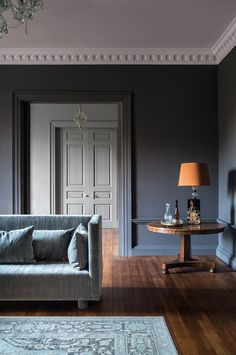 a living room filled with furniture and a lamp