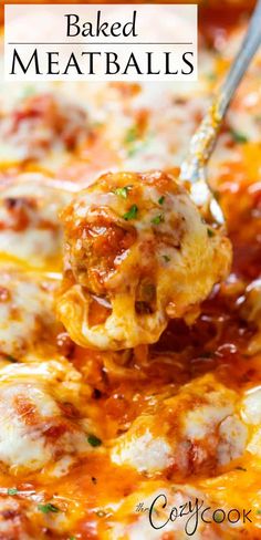 baked meatballs are being scooped from a casserole dish with cheese and tomato sauce