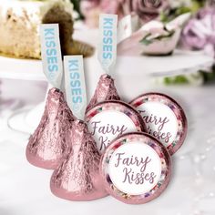 three hershey kisses are sitting next to each other on a table with flowers in the background