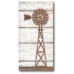 an old wooden wall with a windmill painted on it's side in brown and white