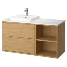 a bathroom vanity with two drawers and a white counter top, in light wood finish