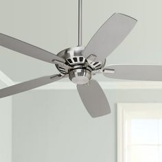 a ceiling fan in a room with white walls