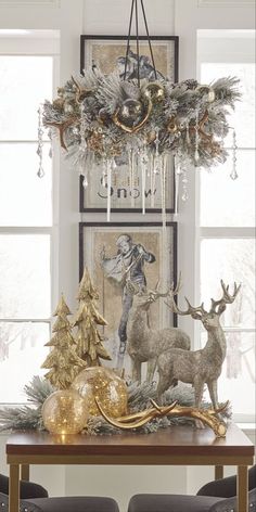 a dining room table decorated for christmas with gold ornaments and deer figurines on it