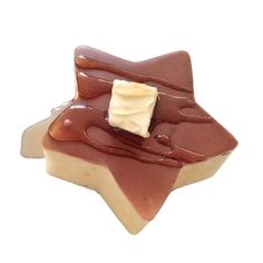 a piece of chocolate and caramel dessert with icing on it's surface