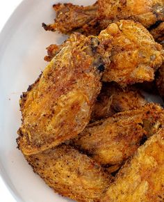 fried chicken pieces on a white plate ready to be eaten