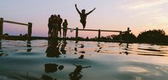 a group of people standing on top of a swimming pool