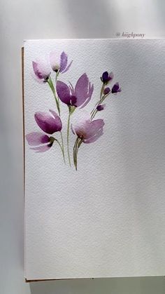 watercolor painting of purple flowers on white paper