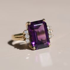 Materials: 14k Yellow Gold, Diamond, and Amethyst 14.3 x 15.6mm Size: 5 3/4 Luxury Oval Amethyst Ring, Elegant Style, Luxury Oval Amethyst Ring For Weddings, Luxury Classic Amethyst Ring, Luxury Amethyst Ring With Intricate Design, Luxury Vintage Amethyst Ring For Formal Occasions, Luxury Classic Amethyst Ring With Gemstone Accents, Luxury Multi-stone Yellow Gold Amethyst Ring, Luxury Marquise Cut Amethyst Ring For Anniversary, Purple Gemstone Diamond Ring In 14k Gold