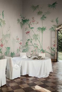 a dining room with a checkered floor and floral wallpapers on the walls