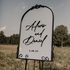 a wedding sign in the middle of a field