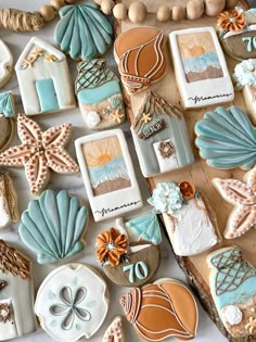 some cookies are laying on a table with seashells and starfish decorations around them