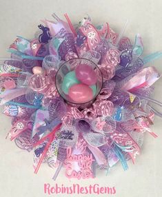 a glass vase filled with pink and blue candies