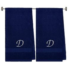 two dark blue towels with the letter d on each one and an embroidered monogram