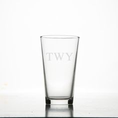 a tall glass with the letter tw on it