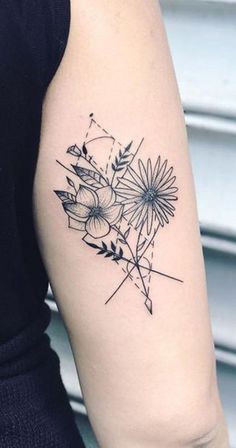 a woman's arm with a tattoo on it that has flowers and geometric shapes