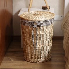 a wicker basket sitting on the floor next to a bed