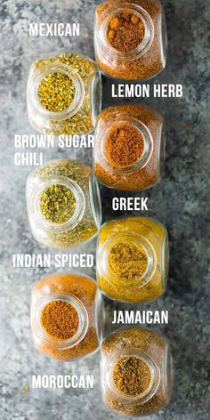 four jars filled with different types of spices