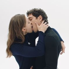 a man and woman are kissing each other