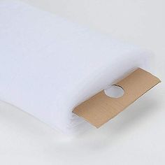 a white pillow with a brown tag on it