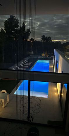 an outdoor swimming pool is lit up at night