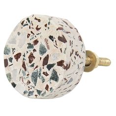 a white and brown marbled knob on a gold plated brass doorknoble