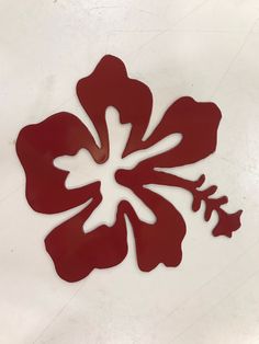 a red flower cut out on the ground