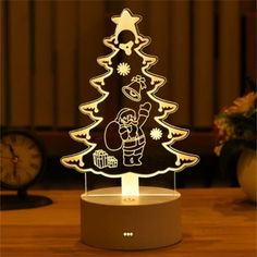 an illuminated christmas tree on top of a table