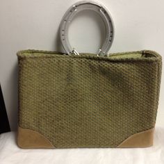 This is a handmade handbag/purse from Stablebags.  Durable wool blend fabric outside (mostly a moss green with a little red and yellow) with a tan suede-type fabric at the bottom corners and bottom.  Inside lining is a moss green cotton with a pocket for a cell phone.  It has a magnetic closure.  It has reinforced sides and bottom.  It has been treated with Scotch Guard fabric protector.  The handles are genuine aluminum racing plates (horse shoes).  The original purchase of this item benefited Fall Green Satchel For Travel, Fall Green Travel Satchel, Fall Travel Green Satchel, Green Fall Travel Satchel, Green Satchel For Daily Use In Fall, Green Fall Satchel For Everyday Use, Everyday Green Satchel For Fall, Everyday Green Fall Satchel, Everyday Green Satchel With Braided Handles