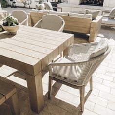 a wooden table sitting on top of a patio