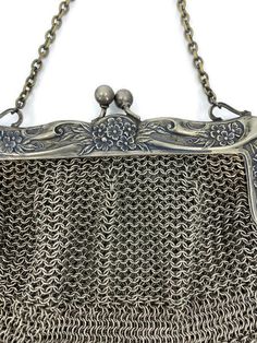 "A wonderful antique German silver purse, the Victorian metal mesh bag has a kiss closure on the hinged floral frame. Marked A B.M.CO Ger. Silver on the frame, the purse is a beautiful example of coin purses from the era The purse is in very good vintage condition. Overall a lovely antique bag and a great addition to your collection. The purse measures approximately 5 1/2\" tall by 5 1/2\" wide." Silver Metal Chainmail Bag, Elegant Silver Bag With Chainmail Detail, Elegant Silver Chainmail Bag, Antique Silver Rectangular Evening Bag, Silver Antique Rectangular Evening Bag, Vintage Handmade Silver Bag, Vintage Silver Handmade Bag, Handmade Victorian Style Silver Bags, Vintage Silver Rectangular Coin Purse