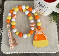 a table topped with candy and decorations next to a coffee cup filled with tea bags