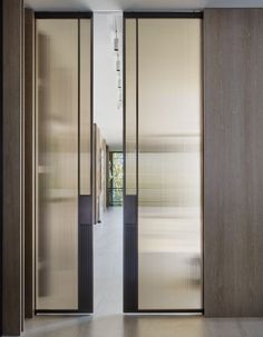 an open door leading to a hallway with sliding glass doors