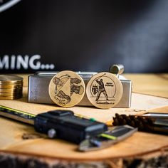 two wooden magnets sitting on top of a table