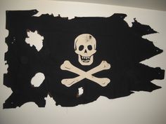 a pirate flag with a skull and crossbones is shown on a white wall