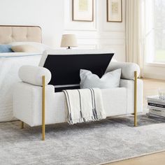 a white chair sitting on top of a rug next to a bed