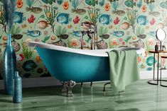 a bath tub sitting in front of a wall covered in seaweed and corals