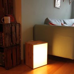 a living room with a couch, coffee table and lamp on the floor in front of it