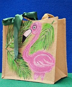 a pink flamingo bag sitting on top of a green table